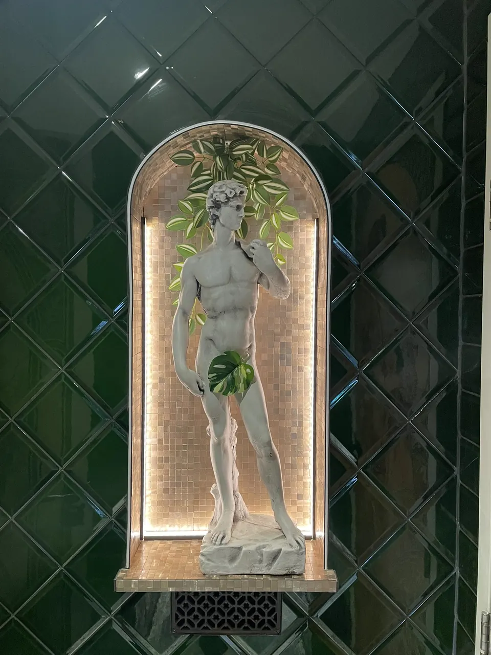 Illuminated niche and green tiling at Café Steijn